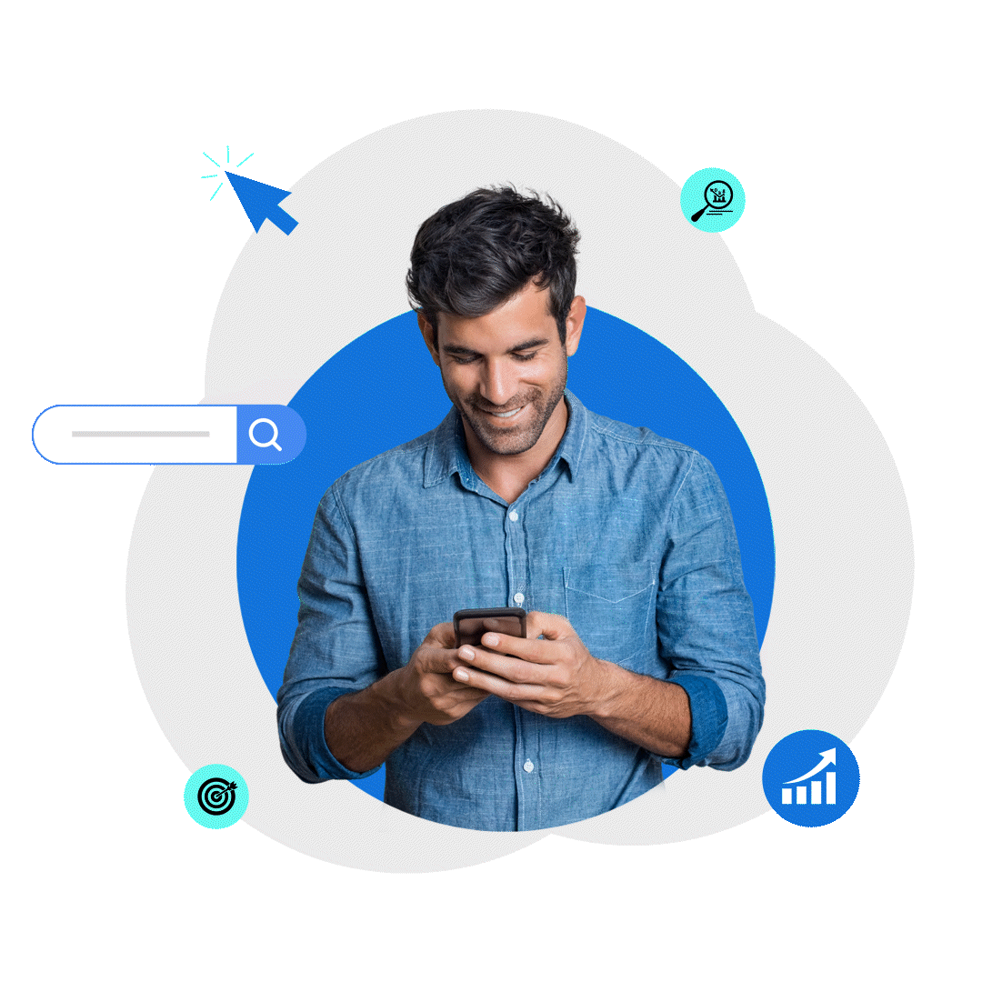 A man with blue shirt looking at his phone and smiling